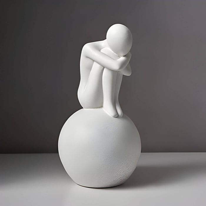 an modern white abstract sculpture of the thinker, sitting on a ball