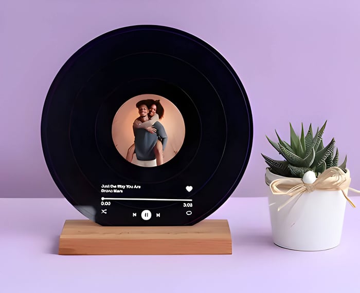 a black record made into a display with a play button