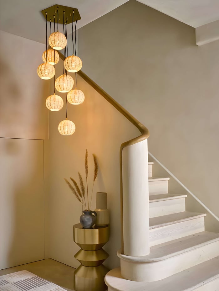 Cluster pendant light in a high-ceilinged hallway or above a staircase