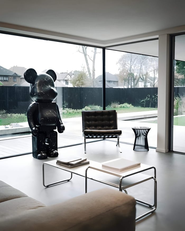 Black Stone giant bear scuplture beside large window creating stunning silhouette