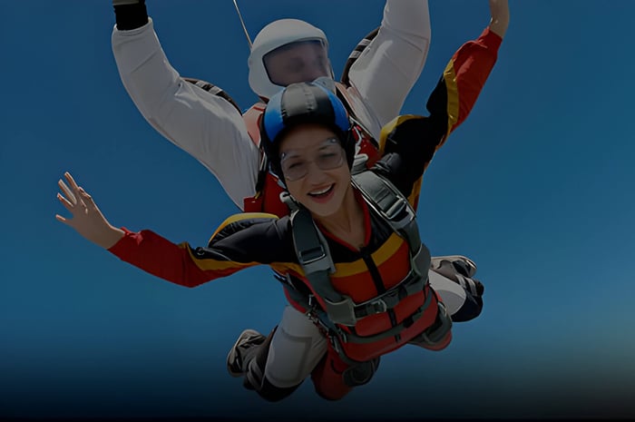 2 people skydiving smiling