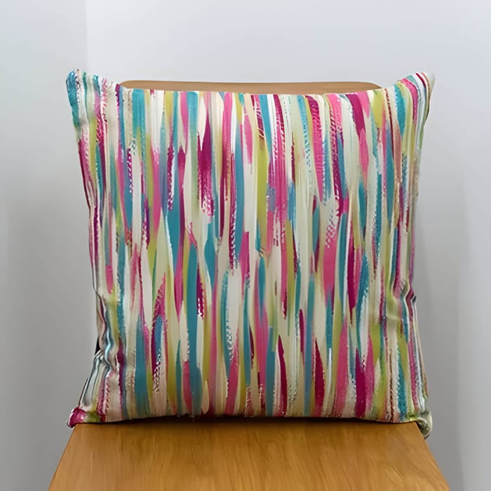 a multicoloured cushion on a wooden chair