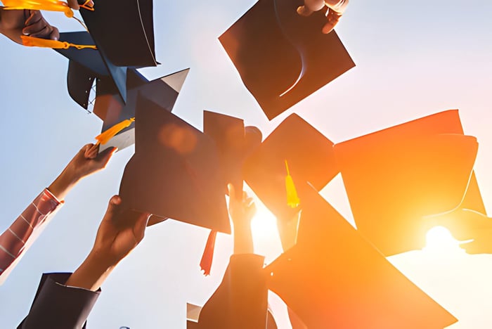 Graduation students throwing their hats into the air
