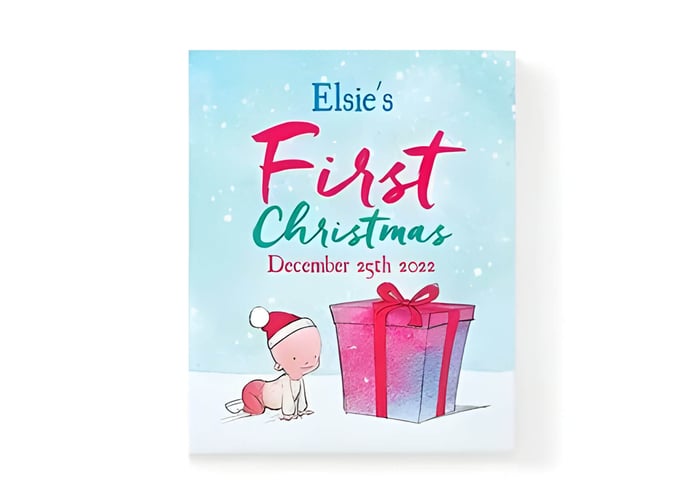 A personalised Christmas story book with a baby and a gift on the front cover
