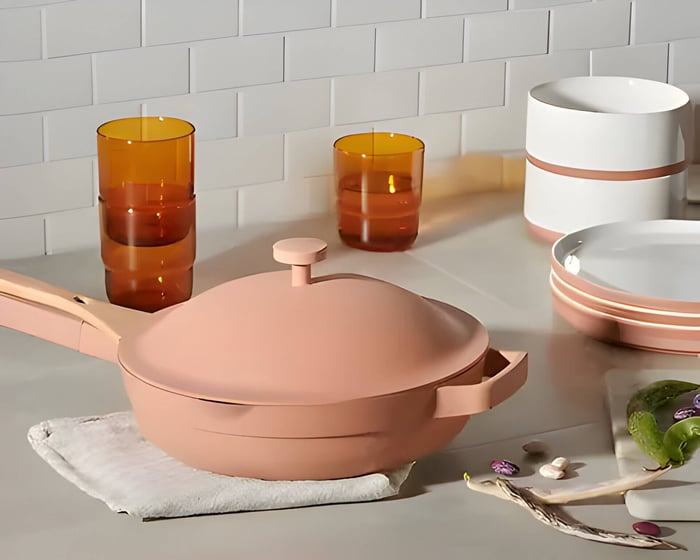 a terracotta colour frying pan with lid