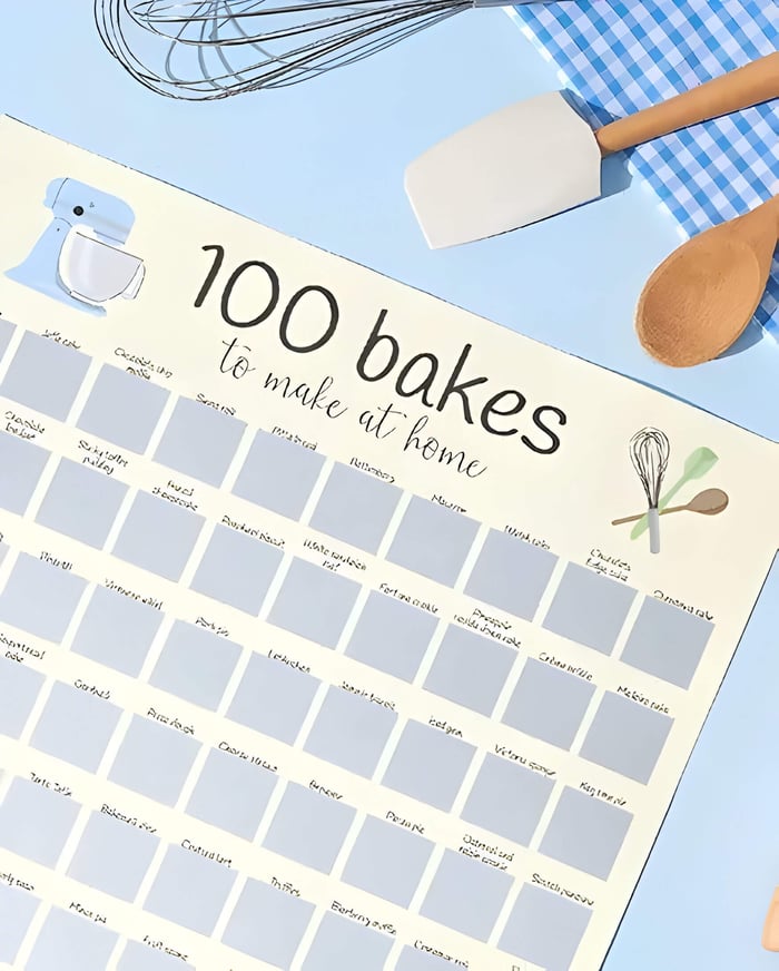 a pale yellow scratch off baking calendar. with various baking items alongside