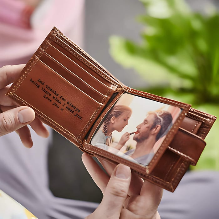 a brown leather wallet with a photo of a man and daughter inside