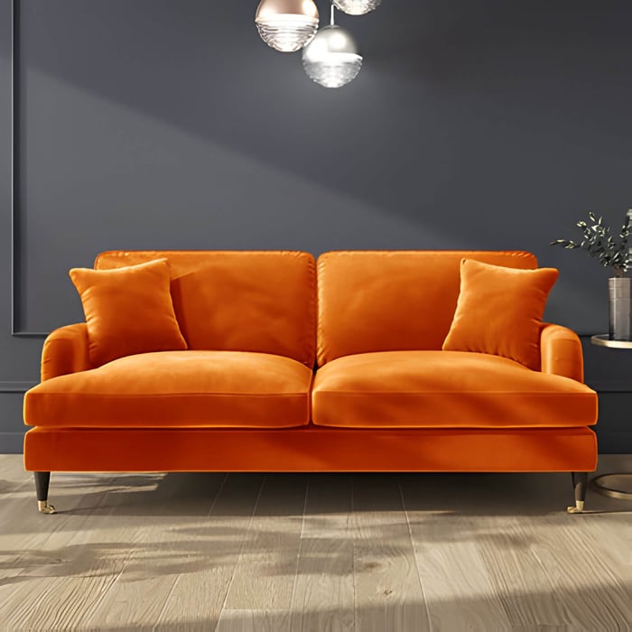 a bright orange sofa against a grey wall