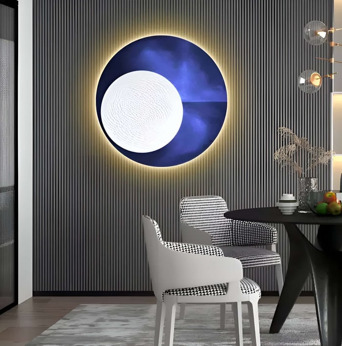 A modern dining area includes houndstooth-patterned chairs around a black table. The wall highlights the Flaria Twilight LED 3D Art Geometric Sandstone by Giant Sculptures, resembling a moon against a dark textured backdrop. A striped wall enhances the artisanal craft ambiance.
