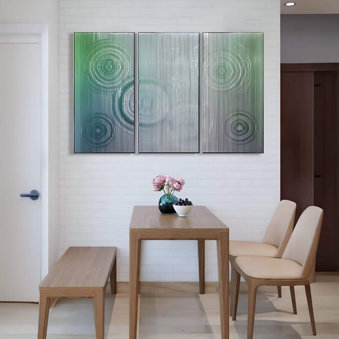 Cirquora Green Gradient Ripple Triptych Acrylic 3D Wall Art with concentric ripple textures in shifting green tones, displayed above a modern dining table with light wood furniture.