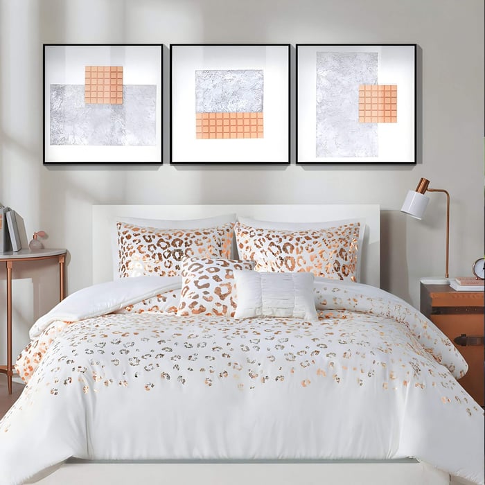 Set of three hand-painted framed acrylic 3D wall art pieces in geometric square designs, displayed above a modern bed with white and copper-toned leopard print bedding.