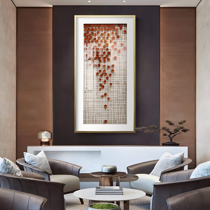 Vertical 3D wall art featuring a white grid backdrop adorned with scattered red flower-like sawdust accents, displayed in an elegant seating area with leather armchairs and modern decor.