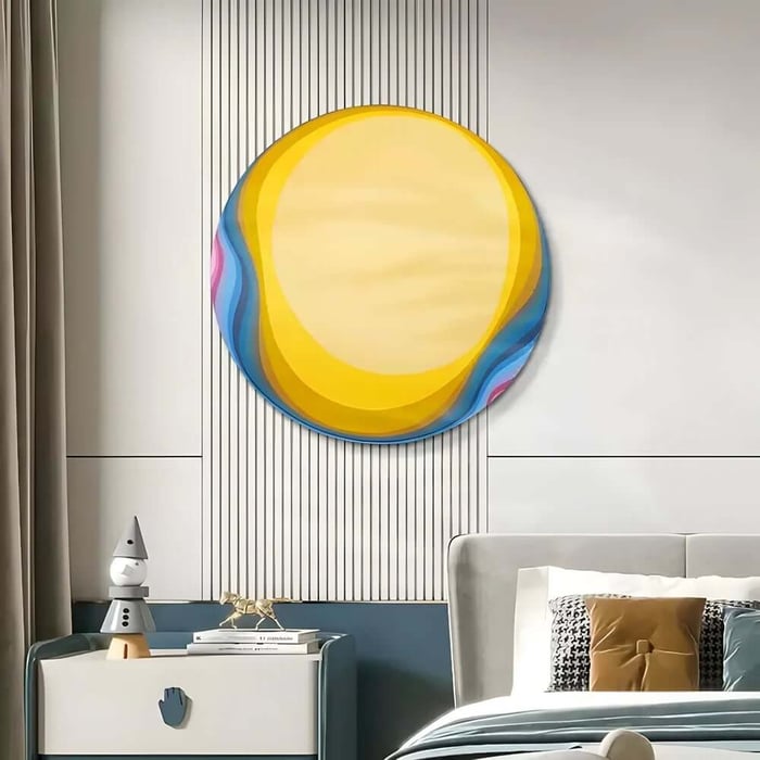Modern bedroom interior with a large circular yellow and blue abstract wall art above the bed, next to a bedside table with decorative objects and stacked books.