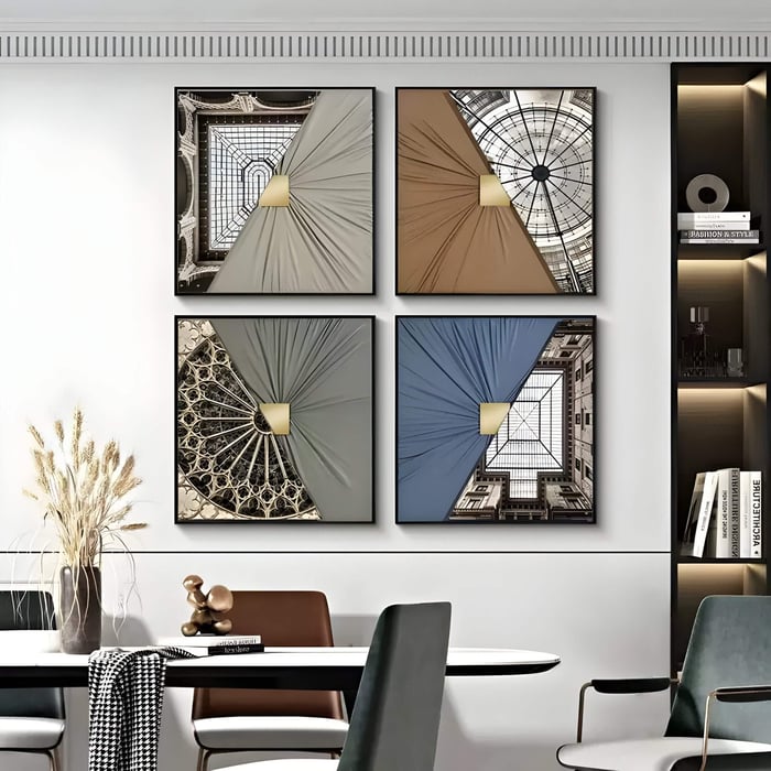 Set of four square 3D wall art pieces combining architectural ceiling photos with folded leather textures and gold accents, arranged above a modern dining table with mixed chairs and neutral decor.