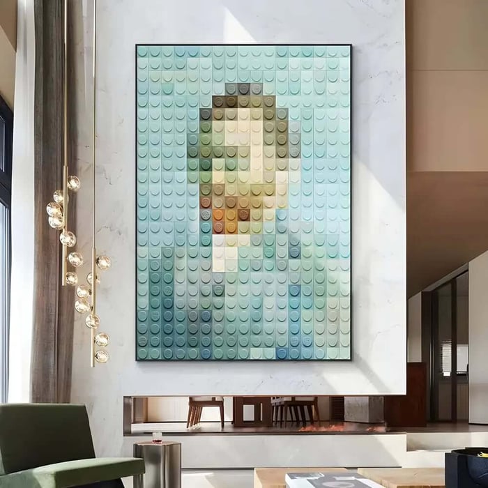 Large Lego-style mosaic portrait artwork in soft blue tones mounted on a bright modern wall above a fireplace.
