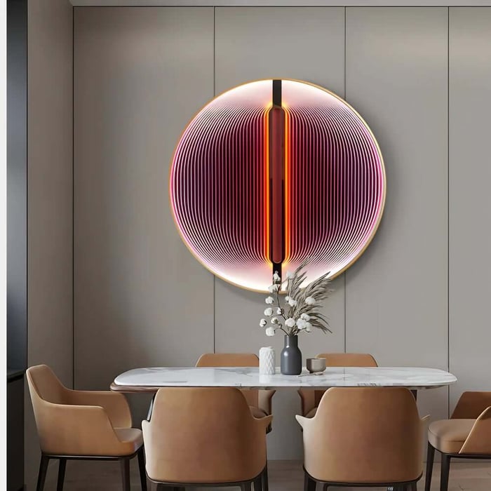 Large circular acrylic wall art with pink gradient glow over dining table.