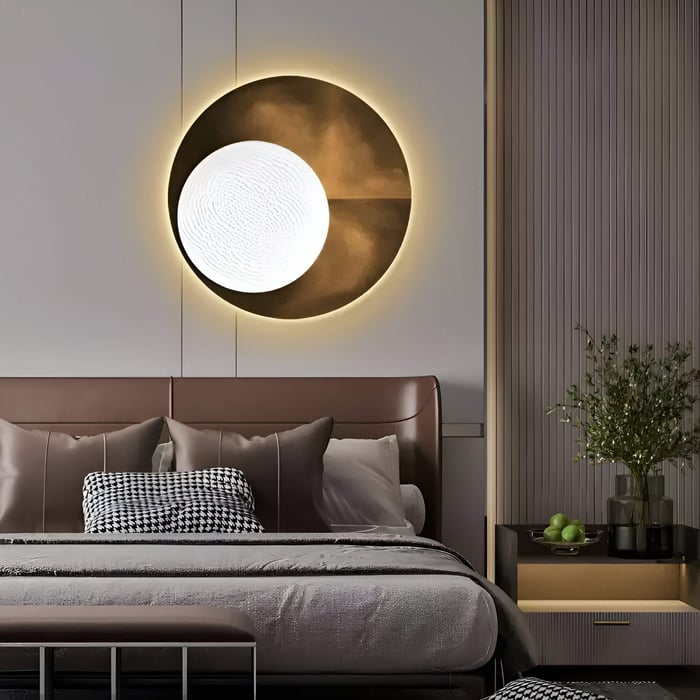 A modern bedroom with a large brown leather headboard, neutral bedding with checkered and solid pillows, and the Flaria Golden 3D LED Wall Art Geometric Sandstone by Giant Sculptures. A nightstand holds a vase of greenery and a bowl of green apples.