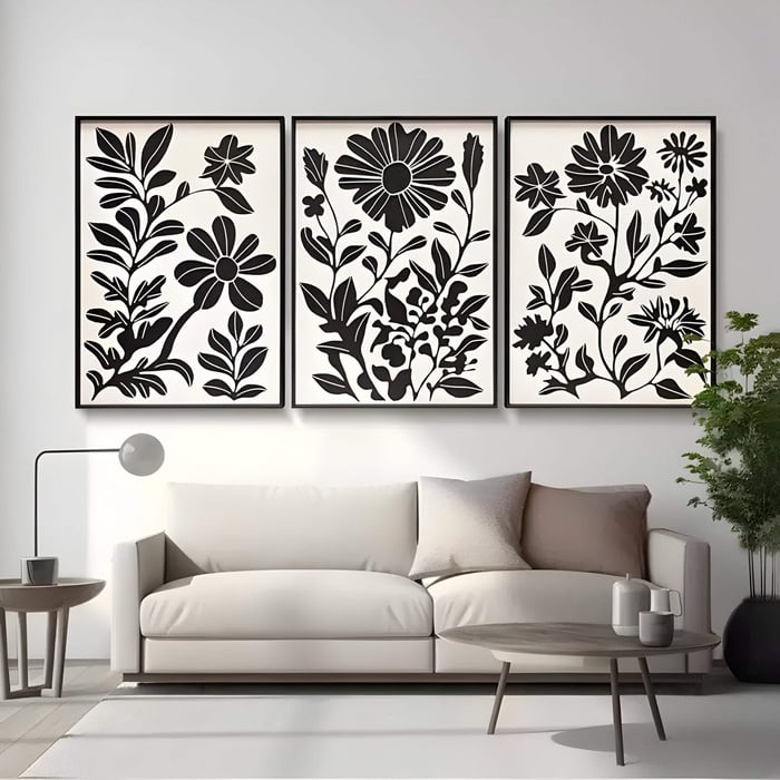 A minimal living room featuring Florentia II Black & White Wood Carving 3D Wall Art with three floral panels above a beige sofa, showcasing modern flower and plant-inspired relief designs.