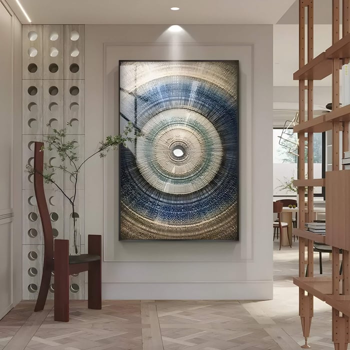 A modern hallway showcases the Auralis Blue Gradient Concentric Circular Cardboard Craft Wall Art by Giant Sculptures. Nearby, a minimalist chair and potted plant complement the decor, while sleek shelving and natural light enhance the contemporary atmosphere.