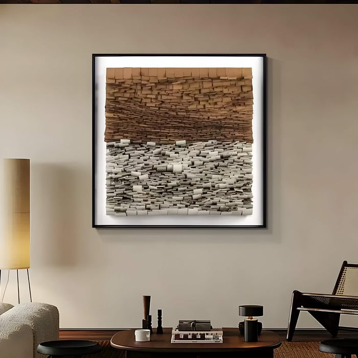 Mixed media artwork in warm earth tones hangs in a cozy lounge, combining clay hues and cream stone-like blocks.