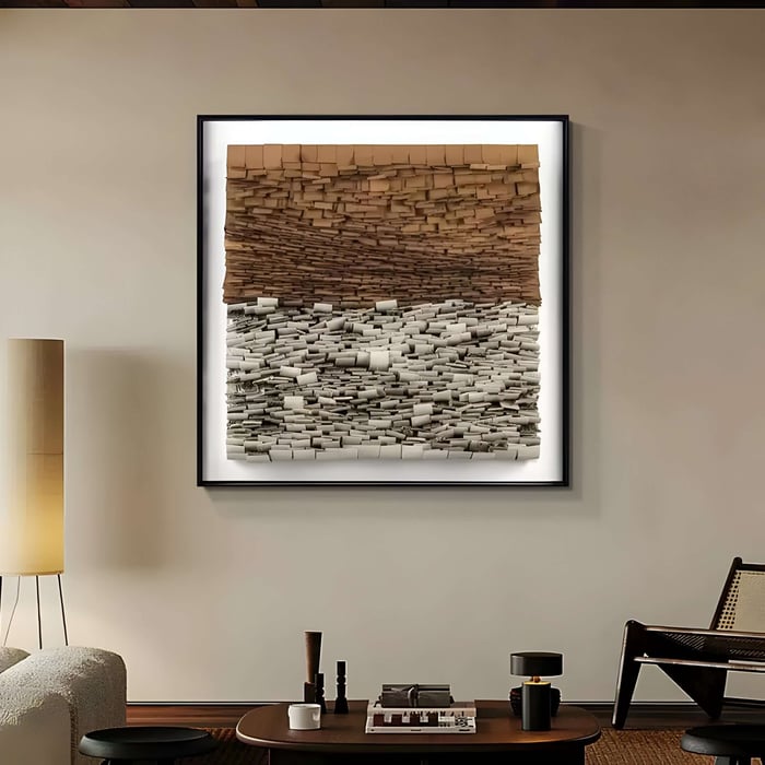 Framed textured wall art made of stacked earthy-toned blocks, illuminated in a warm modern living room.