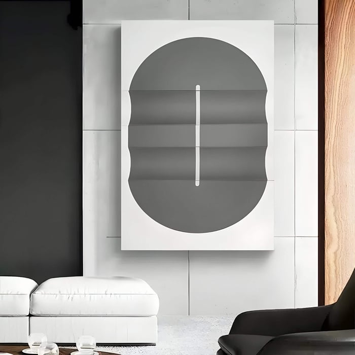 Minimalist interior showcasing a geometric grey and white oval canvas with folded-texture layers, adding depth and symmetry to the space.