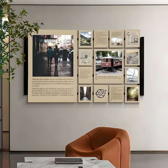 A modern living room showcases a orange chair alongside Momento , a travel-inspired reversible multi-panel wall art from Giant Sculptures. Featuring city streets, nature images, trams, and handwritten text, a potted plant on the left enhances its charm.