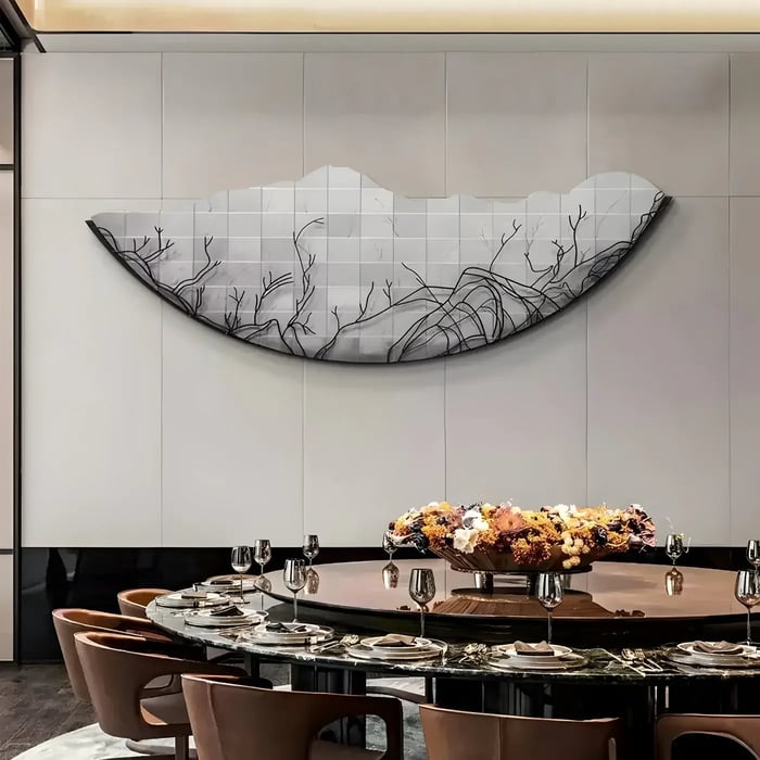 Elegant curved monochrome wall art in formal dining room – A large curved grayscale wall sculpture featuring delicate tree-like patterns above a set dining table.