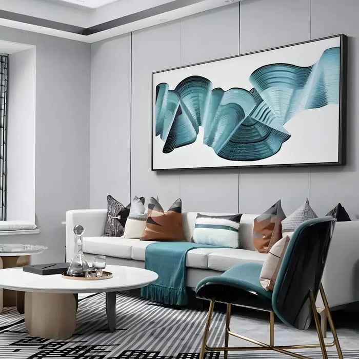 A geometric, textured wall art piece in warm golden tones, featuring bold circular and angular shapes, displayed above a contemporary white sofa with plush, curved seating in a modern living room with wooden furniture and subtle décor elements.