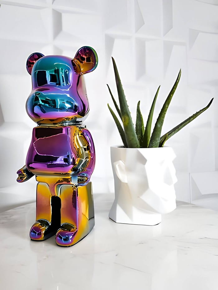 a colour shift giant bear sculpture next to a potted plant