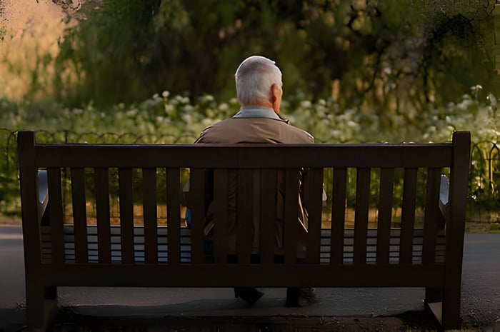 An old man sat on a park bench