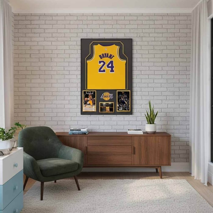 framed basketball jersey wall display above a wooden sideboard in a stylish older child’s bedroom.