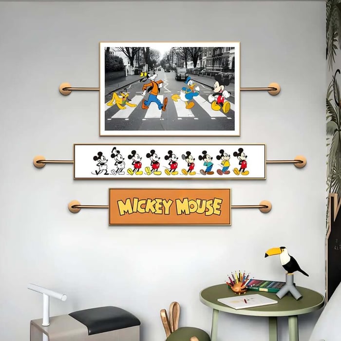 Kids’ room wall art featuring Mickey Mouse-themed prints, including cartoon characters crossing a street and a “Mickey Mouse” name plaque.