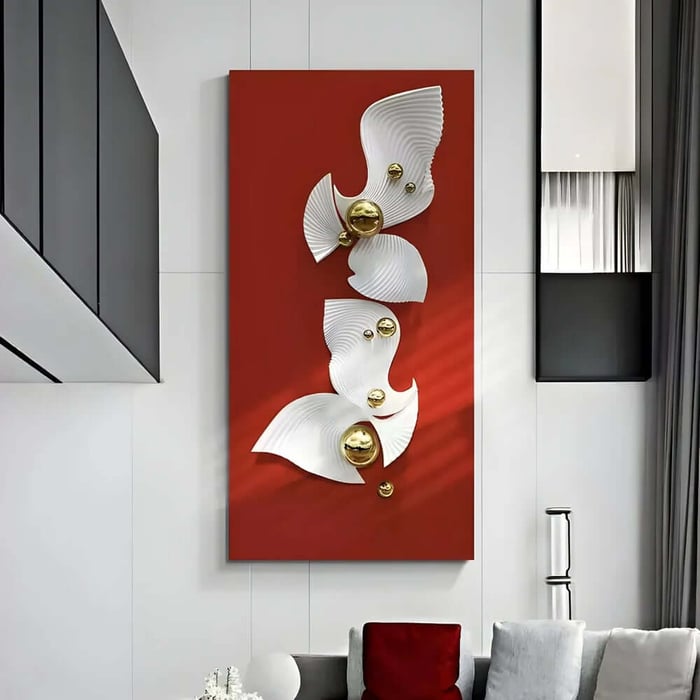 Vertical red wall art panel with flowing white sculptural shapes and small gold spheres mounted in a modern living room with tall white walls and grey curtains.