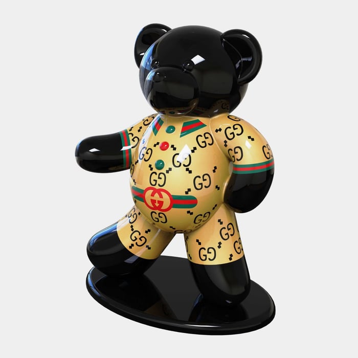 Black and Gold Designer Bear – A black and gold bear sculpture featuring Gucci’s signature monogram and stripe details.