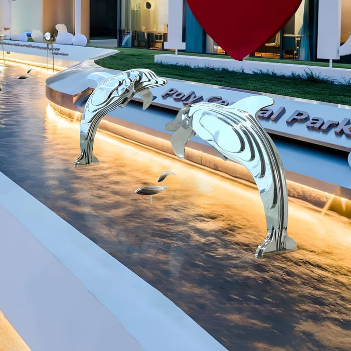 Polished dolphin sculptures leaping in a modern fountain