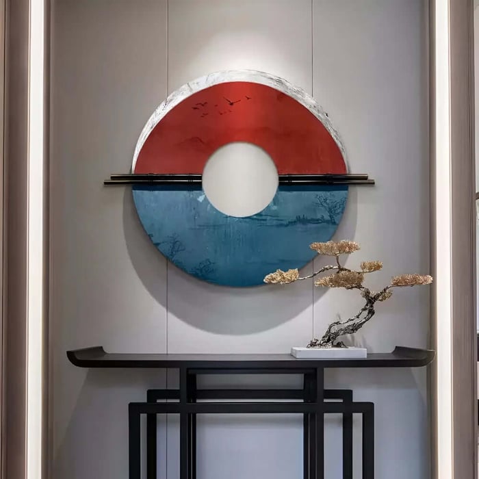 Red and blue circular hallway wall art above a slim console with a sculptural bonsai.