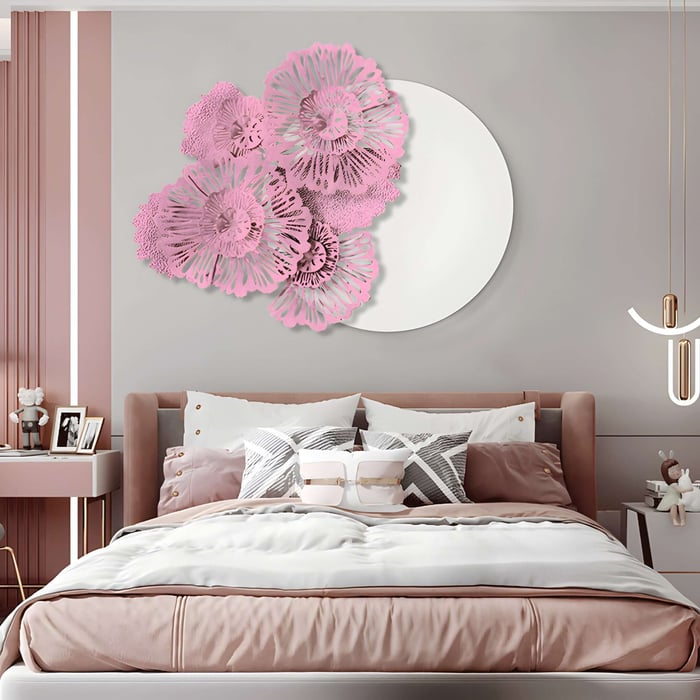 Pink Floral Metal Wall Art Above Bed – A delicate metal wall sculpture of layered pink floral cutouts arranged against a circular white backdrop, adding an artistic touch to a soft pink and neutral-toned bedroom.