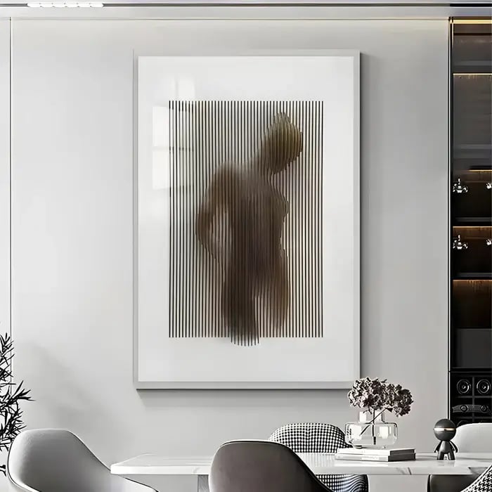 A contemporary dining area with a framed artwork showcasing a blurred human silhouette behind vertical lines, adding an artistic and mysterious ambiance.