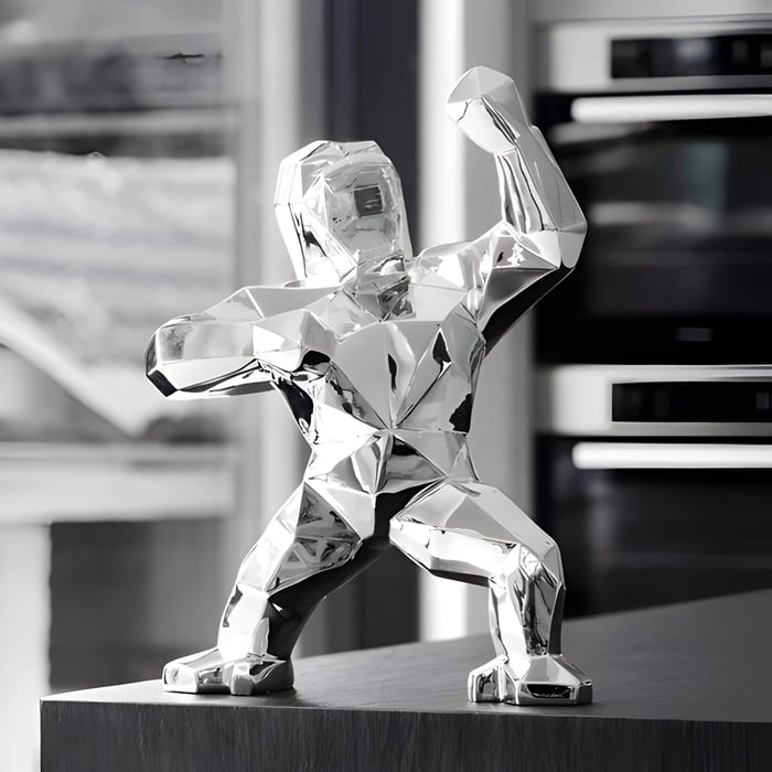 chrome gorilla sculpture in a modern kitchen setting