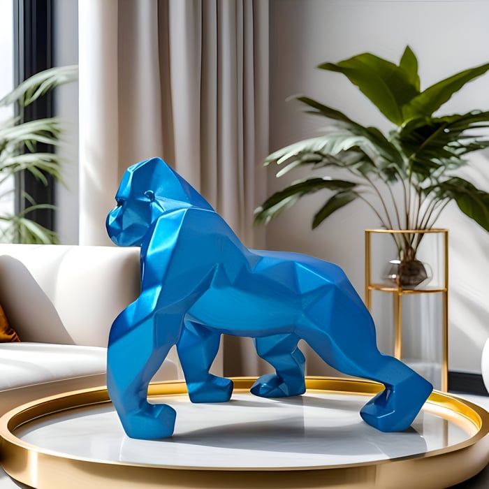 Faceted blue geometric gorilla sculpture on a round gold tray table in a sunlit modern living room with plants and a white sofa.