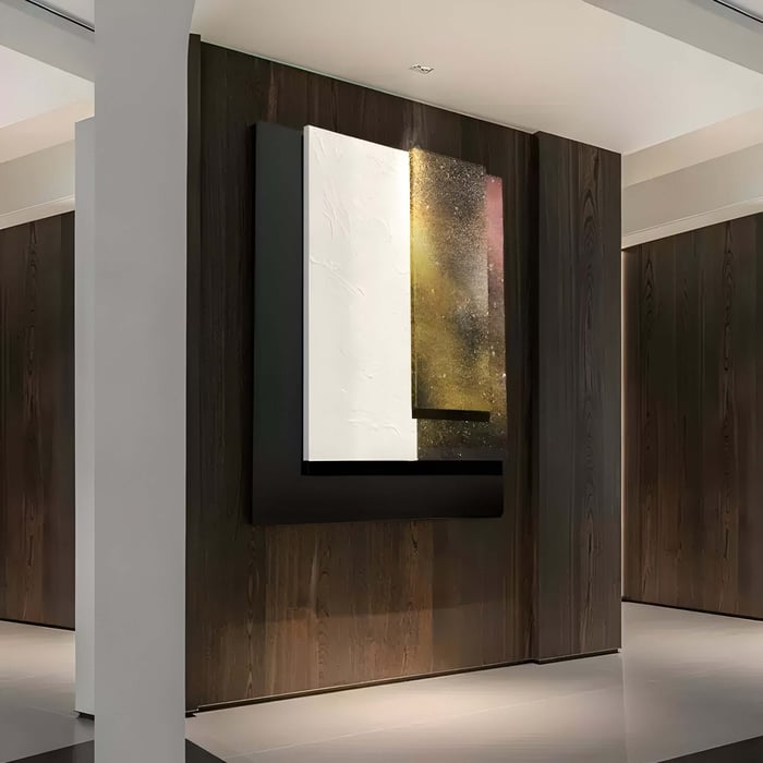 The Giant Sculptures Astra Stardust Gold Textured Wood Carving 3D Wall Art captivates with its celestial-inspired design on a wooden paneled wall, showcasing overlapping rectangular panels that transition from white to dark hues, accentuated by black and gold with hints of pink.