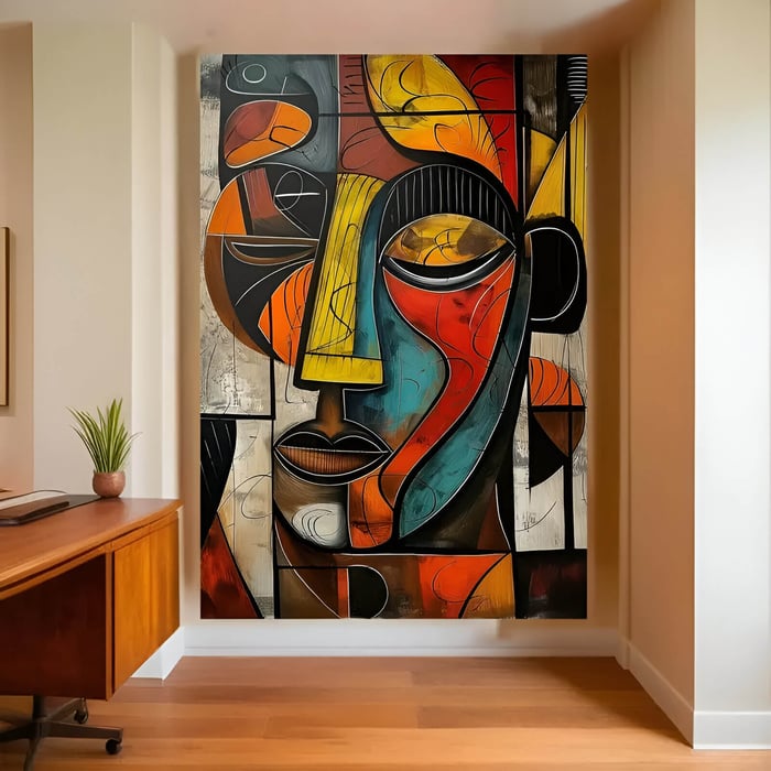 Large abstract cubist painting of a human face in bold geometric shapes and vibrant colors including yellow, red, teal, and black, displayed in a modern home office.