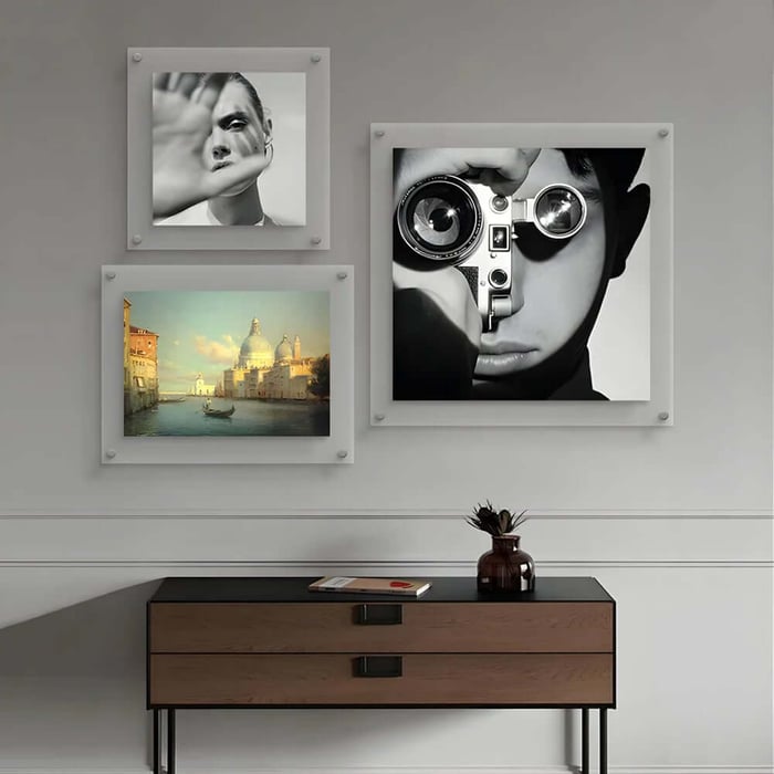 Gallery wall hallway art featuring black and white portrait and classic landscape prints.