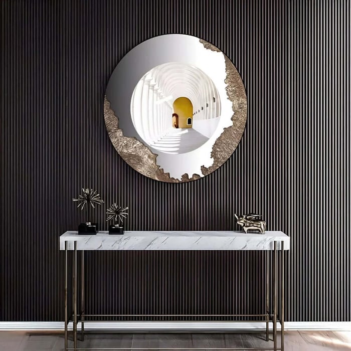 Round modern hallway mirror art with tunnel scene, mounted on a dark ribbed wall above a console.