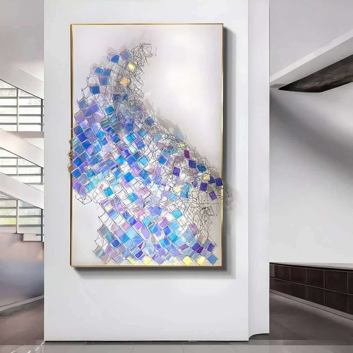 Large abstract iron wall art with iridescent blue and purple squares on a white background hanging in a modern hallway.