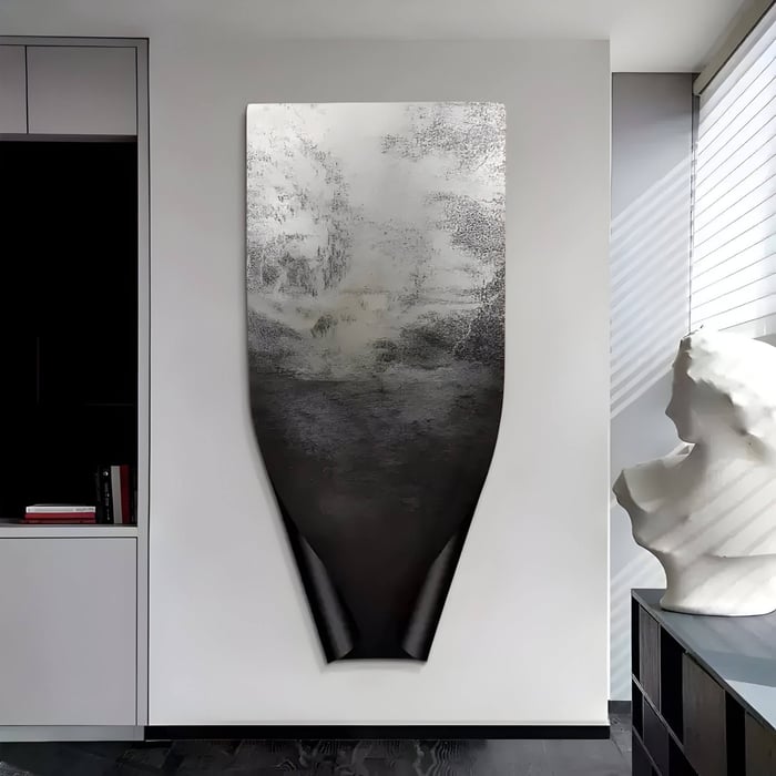 Contemporary room featuring a large matte black sculptural panel with organic texture, mounted on a white wall.