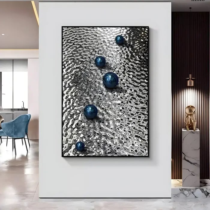 A contemporary hallway showcasing a large vertical metal artwork with a rippling texture and embedded blue reflective spheres, positioned near a marble pedestal with a golden sculpture.