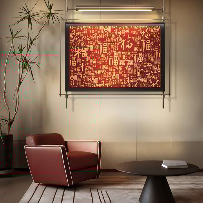 Red and Gold Chinese Calligraphy Artwork in Lounge – A striking illuminated artwork featuring intricate Chinese calligraphy in gold on a deep red background, framed in black and installed above a sophisticated seating area with warm-toned furnishings.