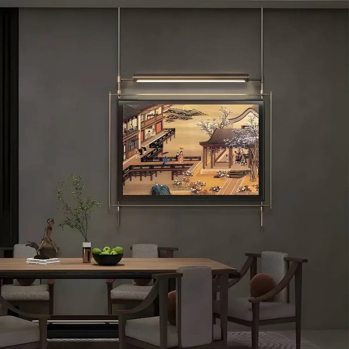 A refined dining space with an illuminated framed artwork depicting a traditional Asian architectural scene, blending heritage art with contemporary interior design.